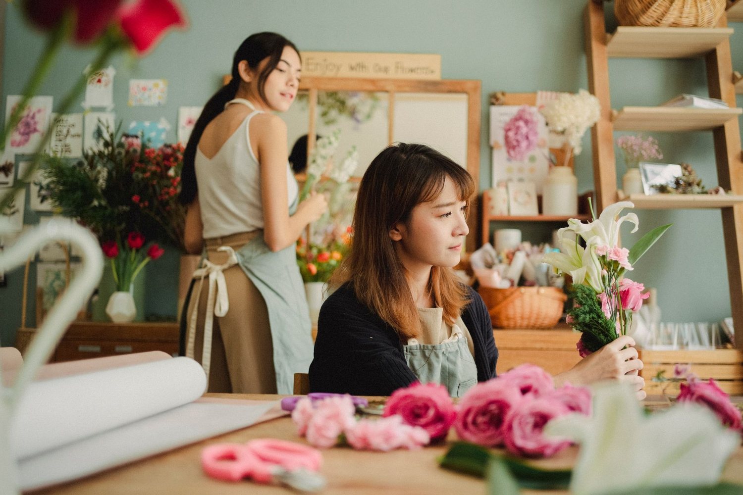 Two florists working inside the shop