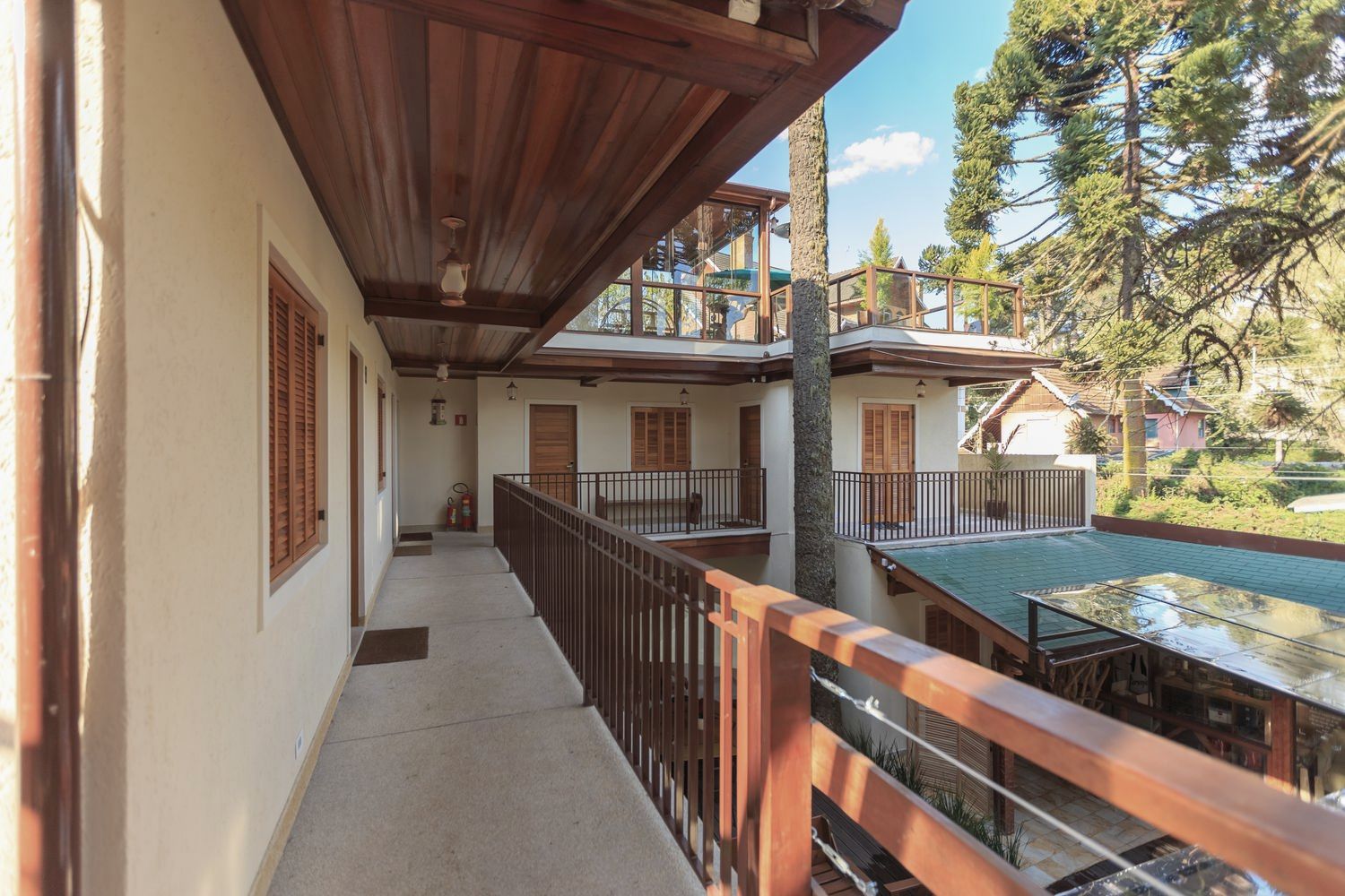 Guest gallery with a timber soffit looking down onto a courtyard pool
