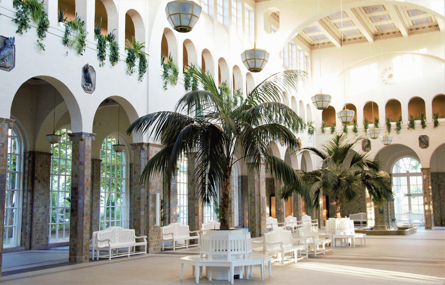Arched Victorian winter garden with palms, now the lounge of a hotel